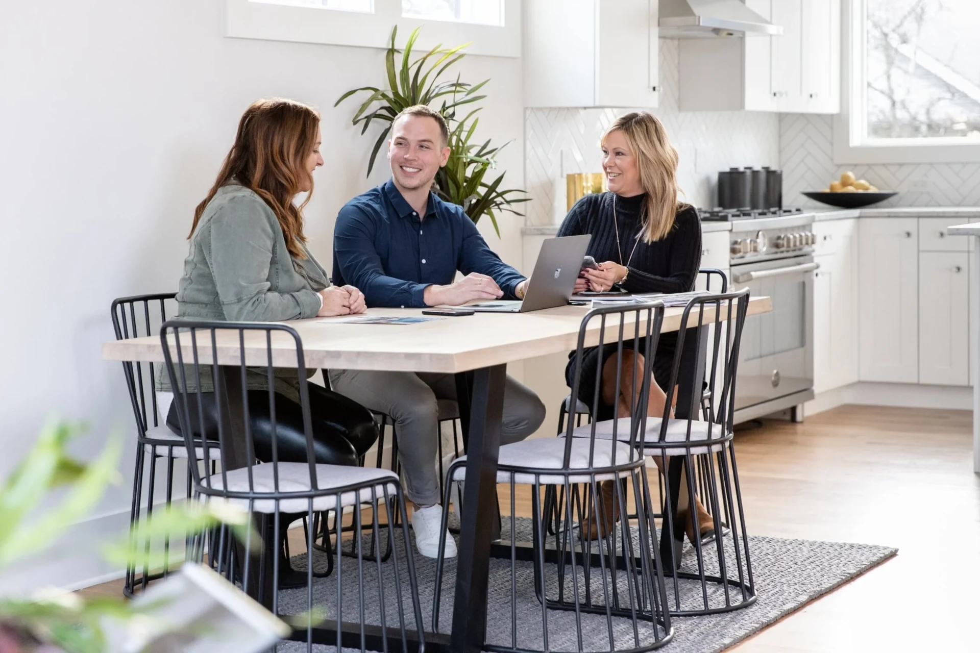 Wesley Gardner reviewing paperwork with clients at a kitchen table